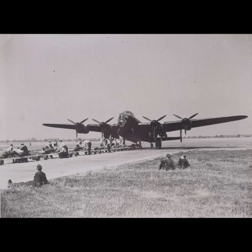 Lancaster bomber arming with Sqn Ldr Hughie Everitt on grass